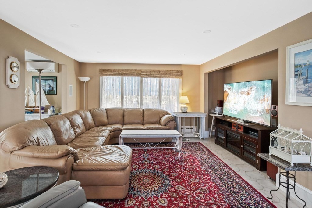 928 Shore Road Bourne, MA 02559 - Photo 9 of 32 a living room with furniture and a flat screen tv