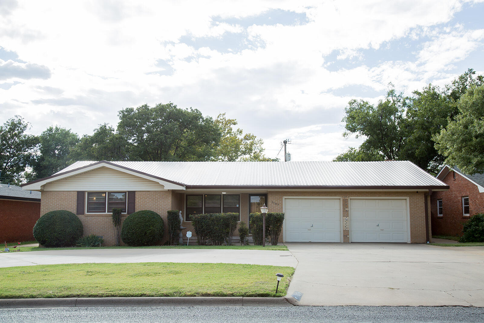 1107 Ennis Street Plainview, TX 79072 - Photo 1 of 42 a front view of a house with a yard and garage