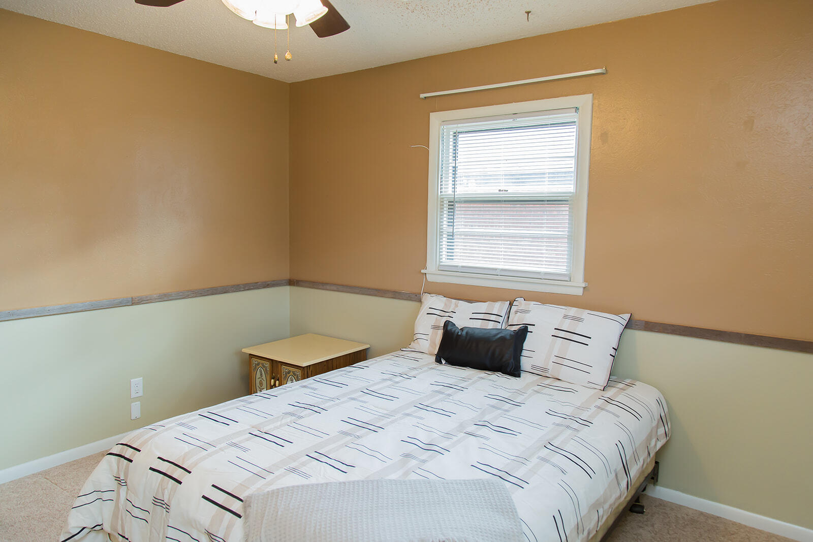 1107 Ennis Street Plainview, TX 79072 - Photo 25 of 42 a bedroom with a bed and a window