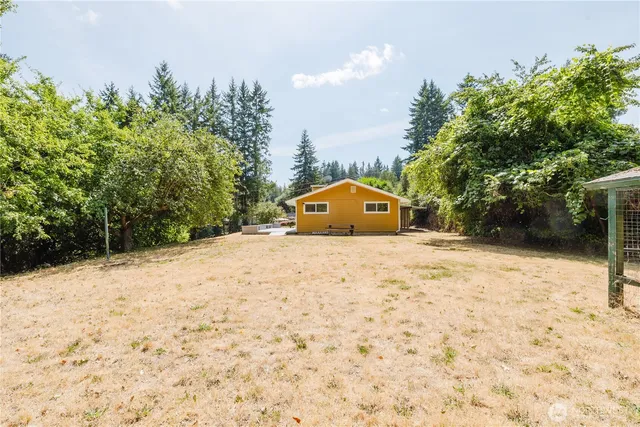 an empty room with wooden floor and mirror