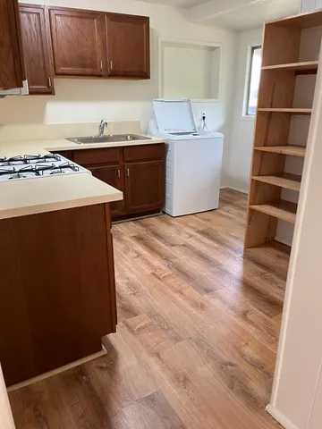 a kitchen with stainless steel appliances a stove refrigerator sink and cabinets