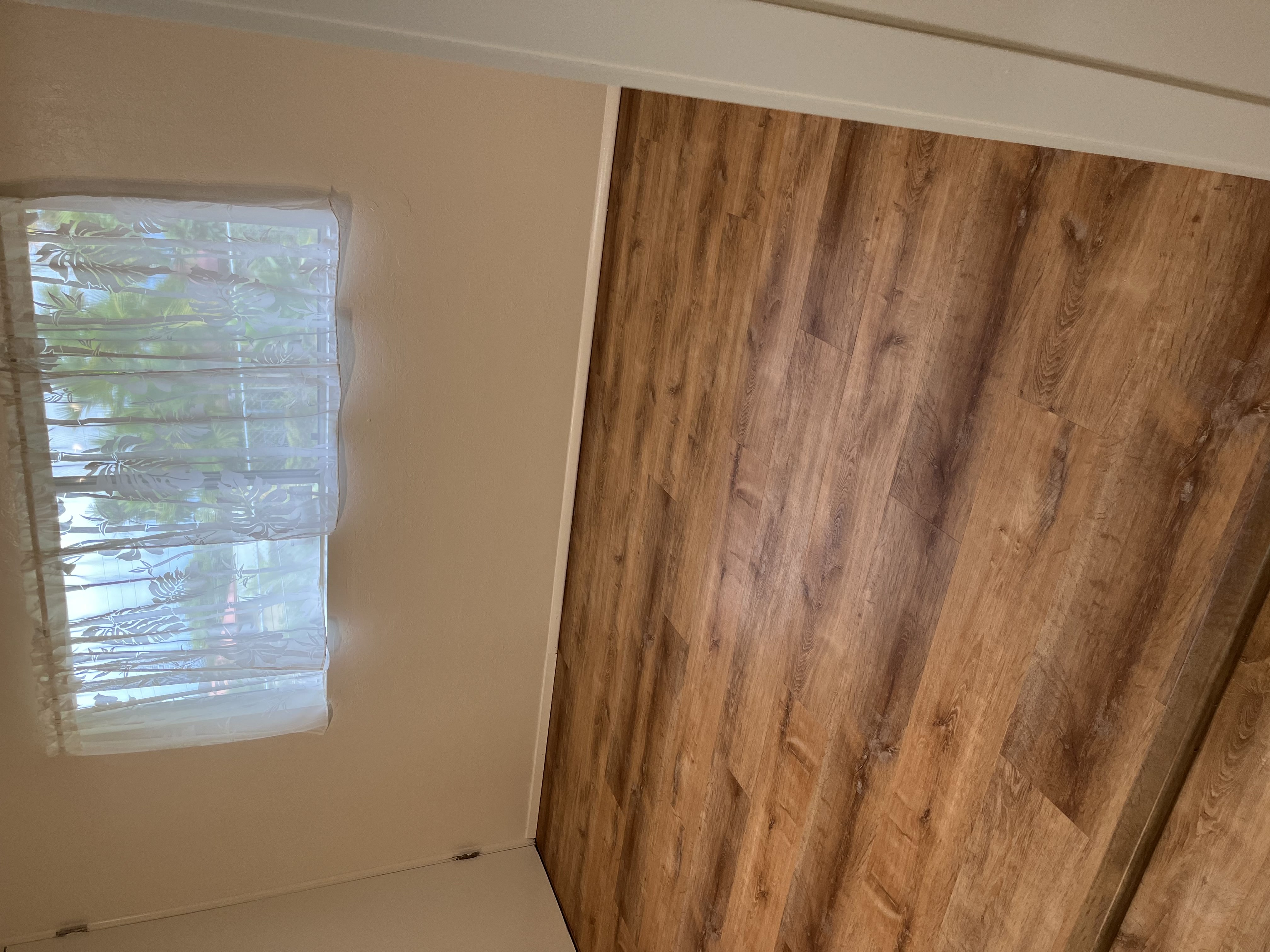 483 Hoopuni Way Hilo, HI 96720 - Photo 13 of 14 a view of a room with wooden floor and windows