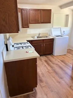 a kitchen with stainless steel appliances a stove a sink and a refrigerator