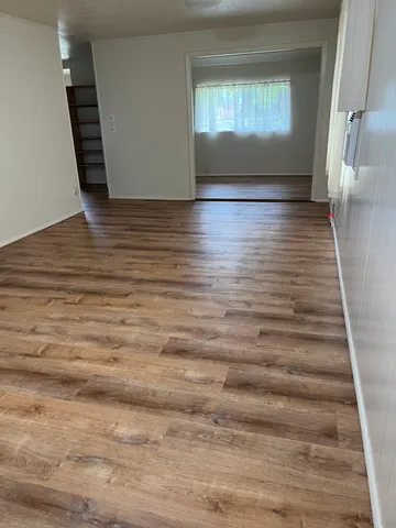 a view of wooden floor and windows in a room