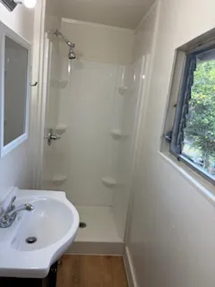 a bathroom with a sink and shower