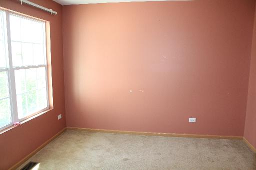 1319 Roth Drive Joliet, IL 60431 - Photo 2 of 10 an empty room with a window