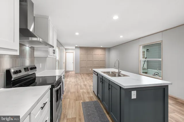 a kitchen with a stove sink and cabinets