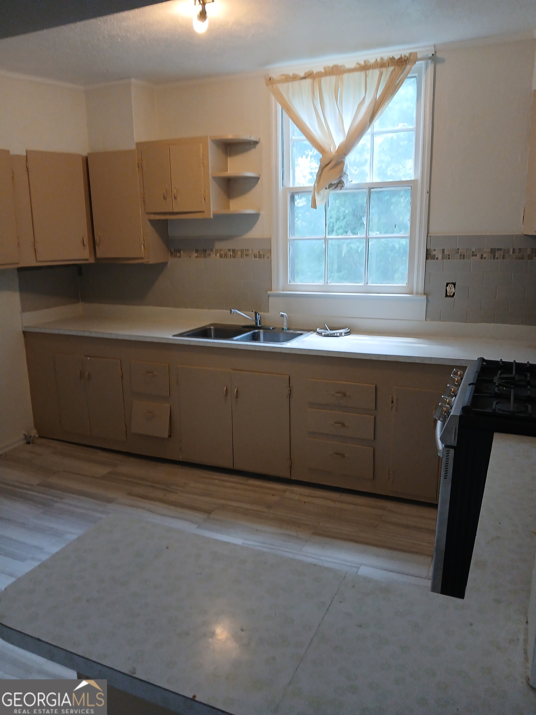 678 Dixie Avenue Macon, GA 31206 - Photo 11 of 19 a kitchen with a sink and a window
