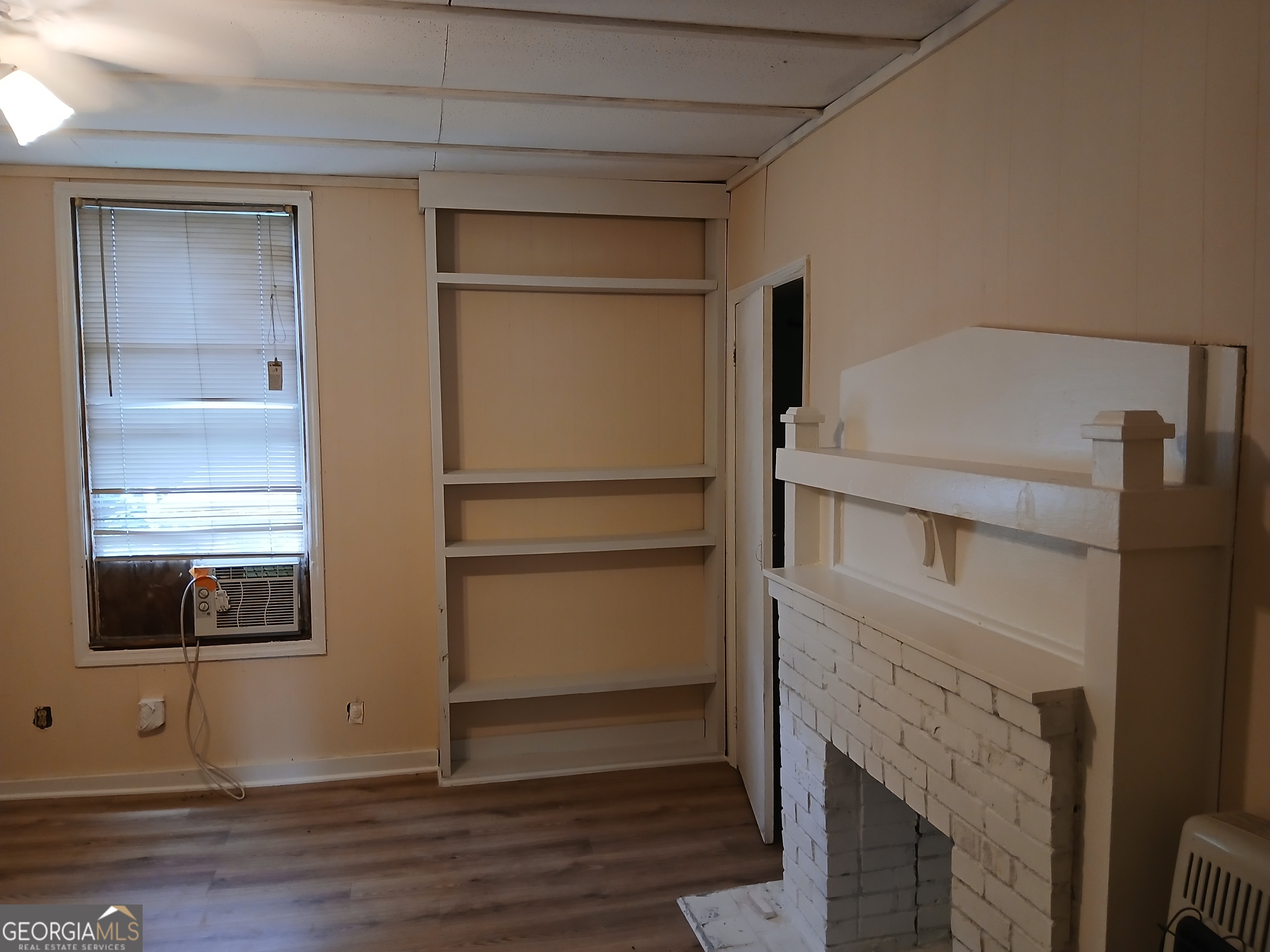 678 Dixie Avenue Macon, GA 31206 - Photo 14 of 19 a room with a fireplace and wooden floor