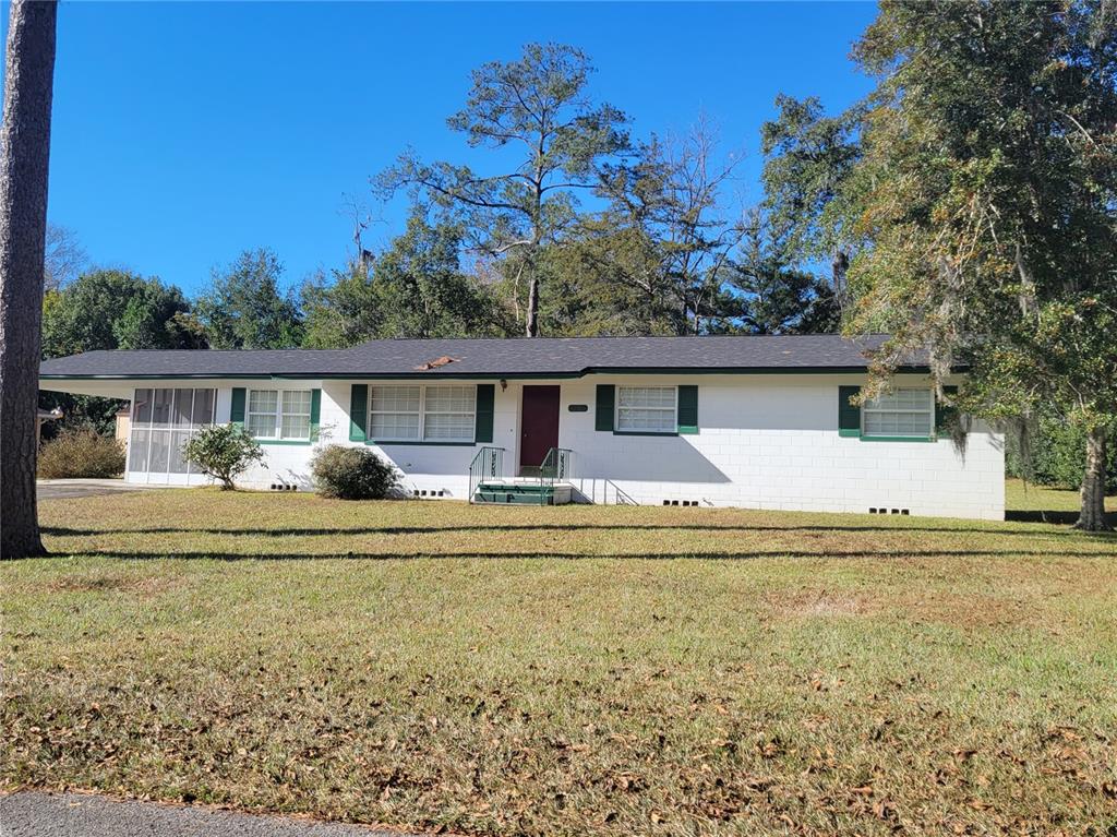 1106 Northeast 17th Terrace Ocala, FL 34470 - Photo 1 of 1 a front view of house with yard having outdoor seating