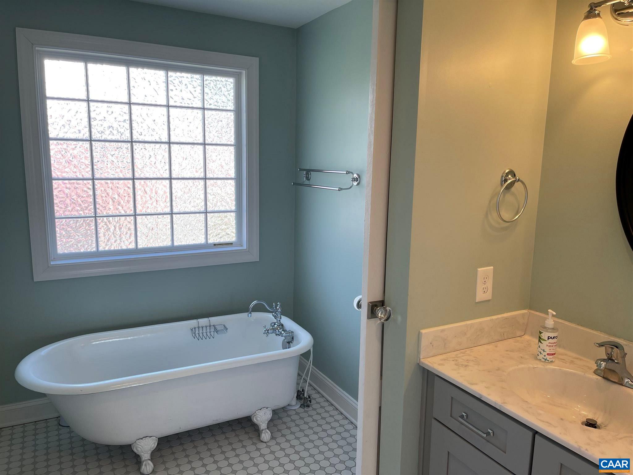 1953 Thomson Road Charlottesville, VA 22903 - Photo 7 of 7 a white bath tub sitting next to a bathroom sink