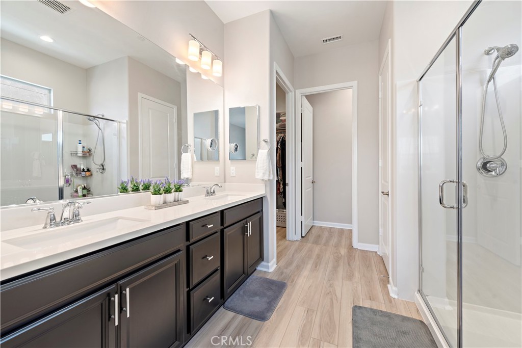 24301 Overlook Drive Corona, CA 92883 - Photo 12 of 20 a spacious bathroom with a double vanity sink a mirror and shower