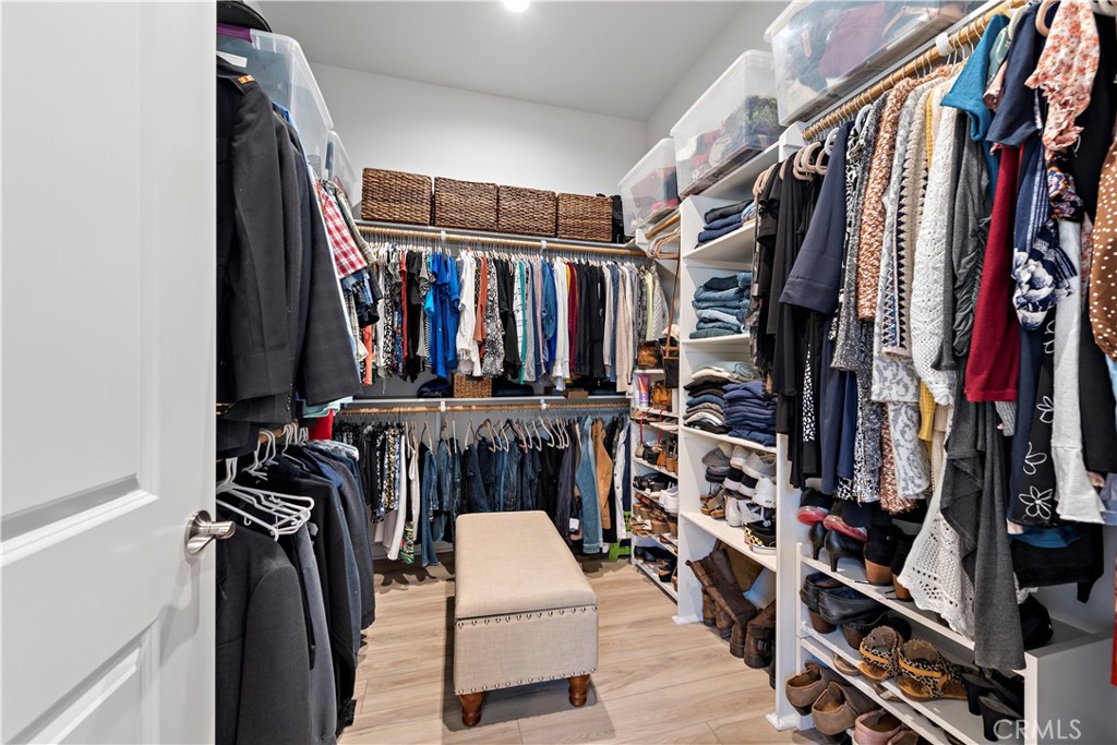 24301 Overlook Drive Corona, CA 92883 - Photo 13 of 20 a view of walk in closet with clothes and shoes