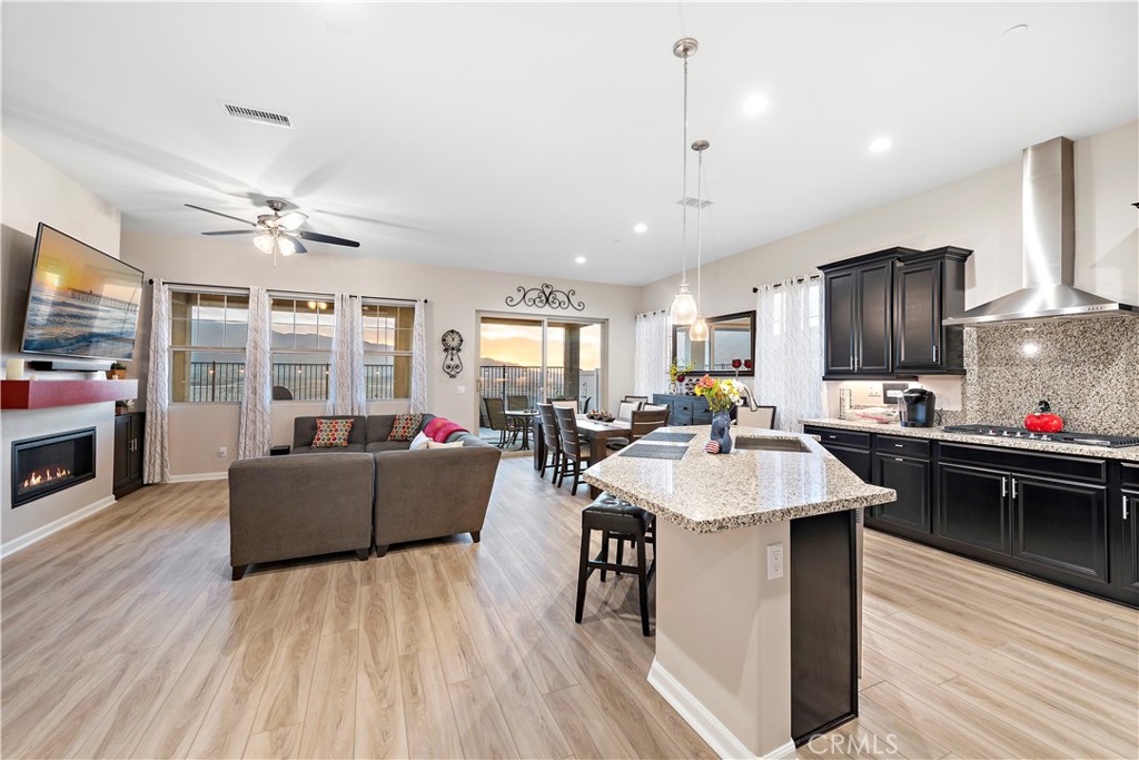 24301 Overlook Drive Corona, CA 92883 - Photo 8 of 20 a living room with furniture a fireplace and a flat screen tv