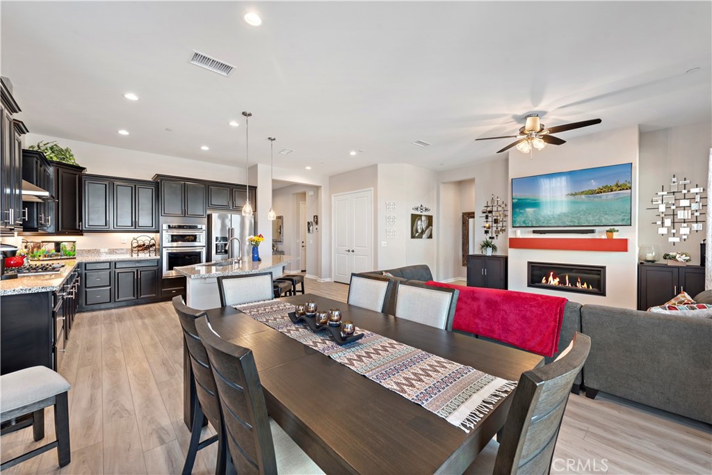 24301 Overlook Drive Corona, CA 92883 - Photo 9 of 20 a living room with furniture a flat screen tv and kitchen view