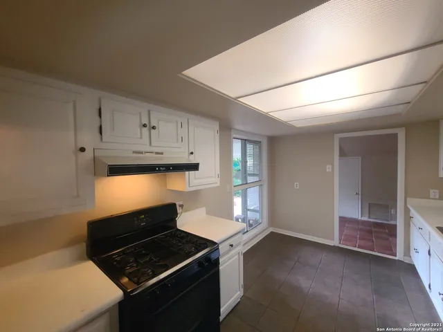 a kitchen with granite countertop a stove and a refrigerator