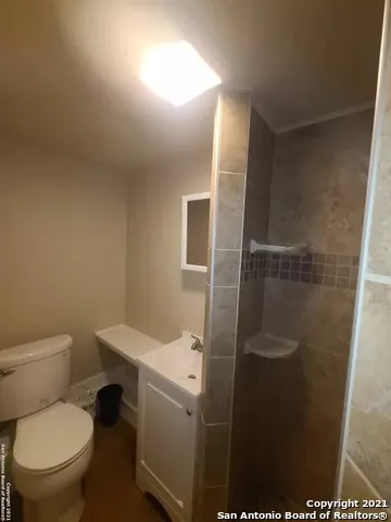 a bathroom with a toilet and a shower