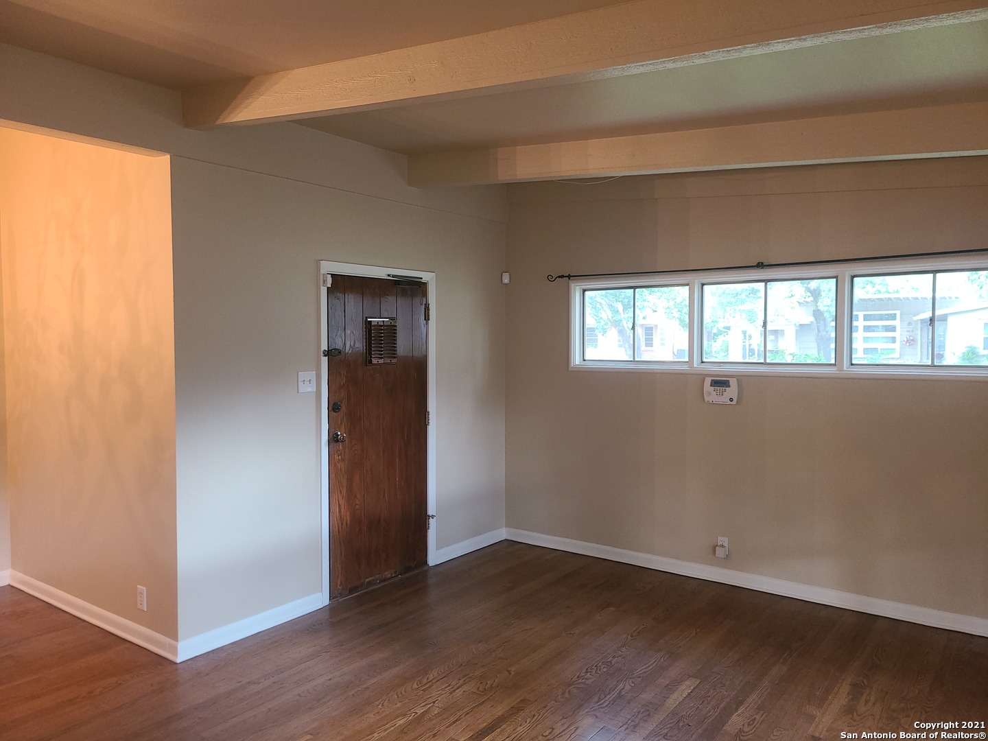 106 Ridgehaven Place San Antonio, TX 78209 - Photo 5 of 22 an empty room with wooden floor and windows