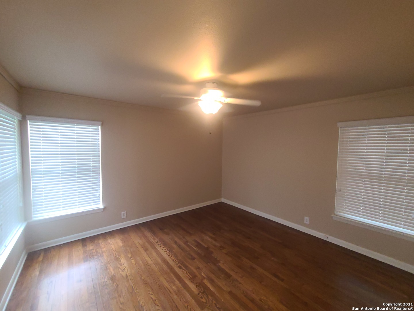 106 Ridgehaven Place San Antonio, TX 78209 - Photo 6 of 22 an empty room with wooden floor and windows