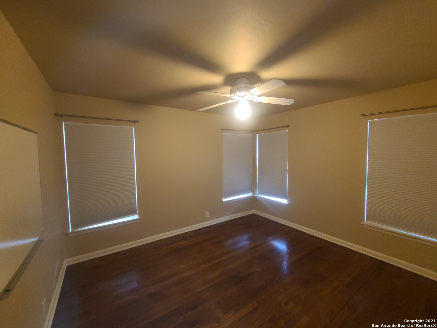 106 Ridgehaven Place San Antonio, TX 78209 - Photo 8 of 22 an empty room with wooden floor and windows