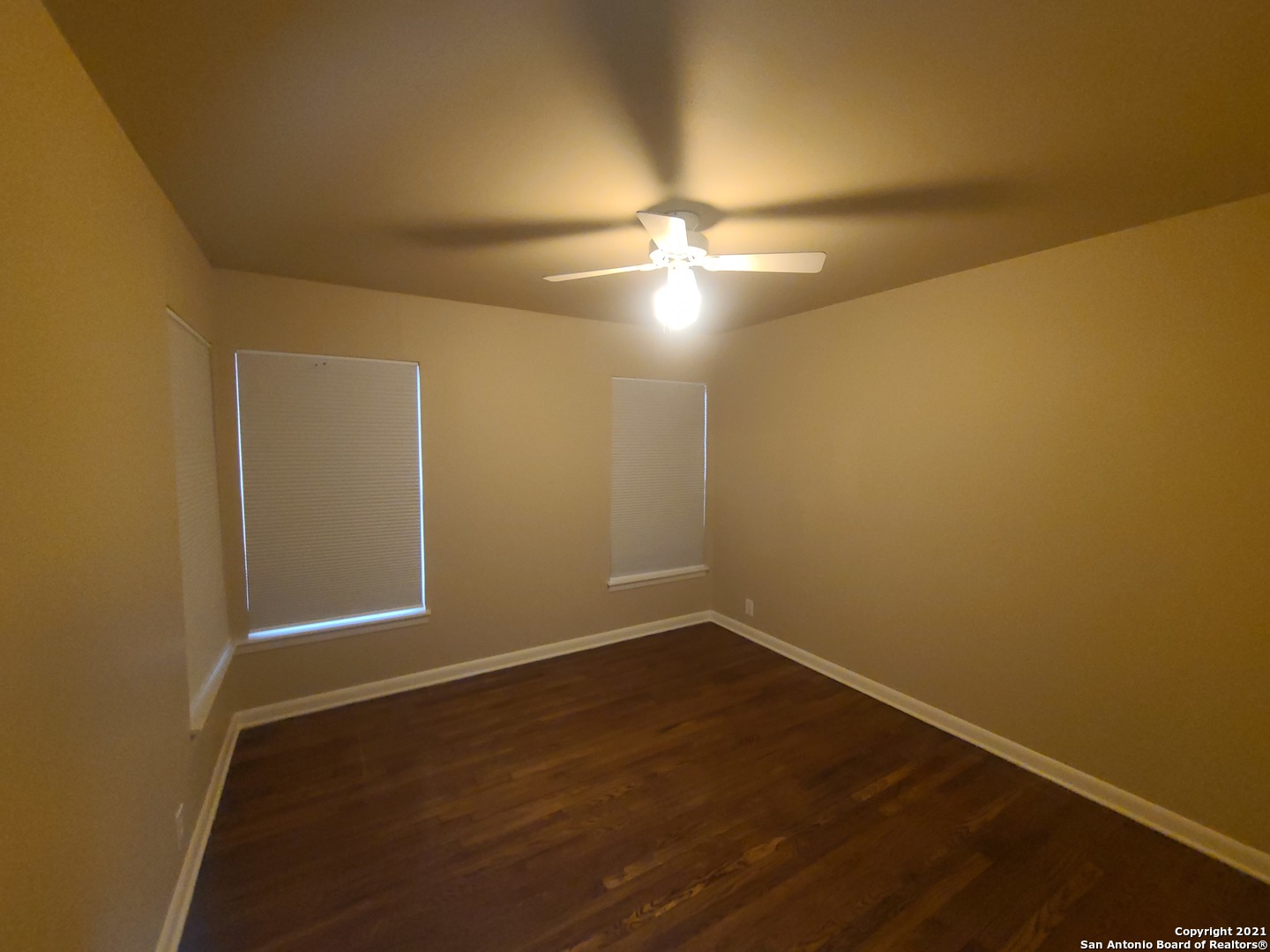 106 Ridgehaven Place San Antonio, TX 78209 - Photo 9 of 22 an empty room with wooden floor and fan