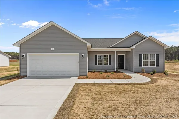 a front view of house with yard space and seating area