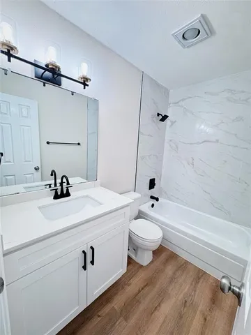 a bathroom with a sink a toilet and a bathtub