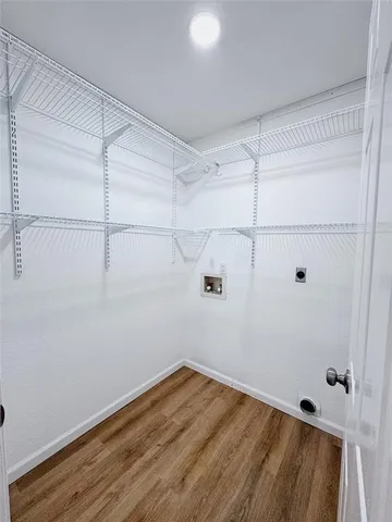 a view of a room with wooden floor