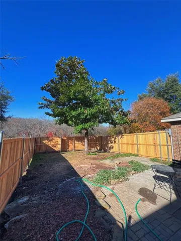 a view of a backyard with sitting area