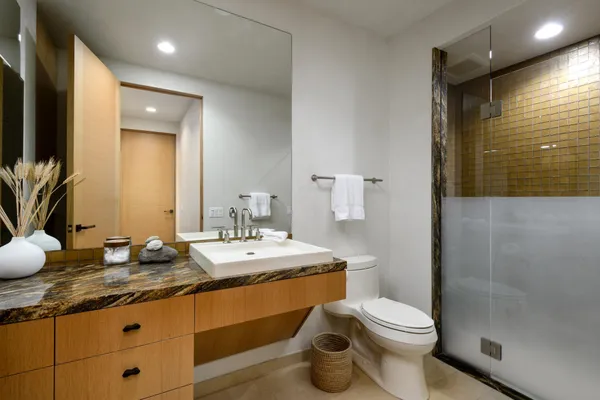 a view of a street with a fountain and a lots of trees