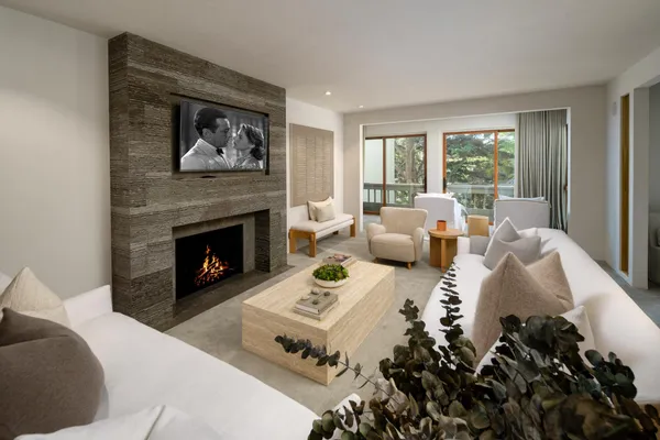 a living room with furniture a fireplace and a table