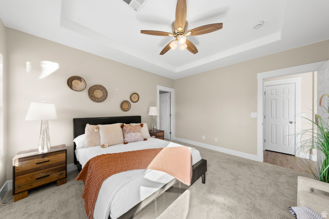 1570 South Rio Virgin Drive Washington, UT 84780 - Photo 28 of 71 Bedroom with carpet, a tray ceiling, and a ceiling fan