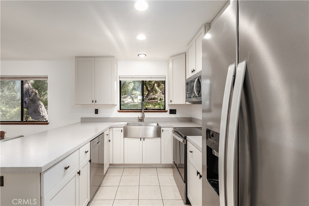 3175 Arena Avenue Atascadero, CA 93422 - Photo 11 of 40 a kitchen with a sink a refrigerator and window