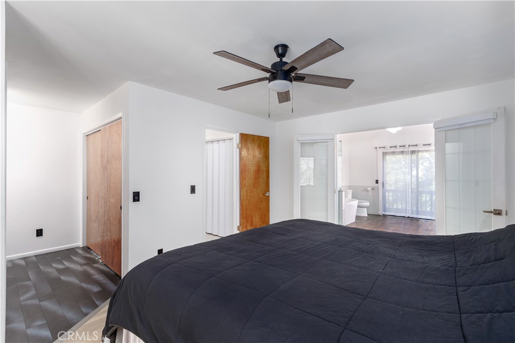 3175 Arena Avenue Atascadero, CA 93422 - Photo 14 of 40 a bedroom with a bed and a chandelier