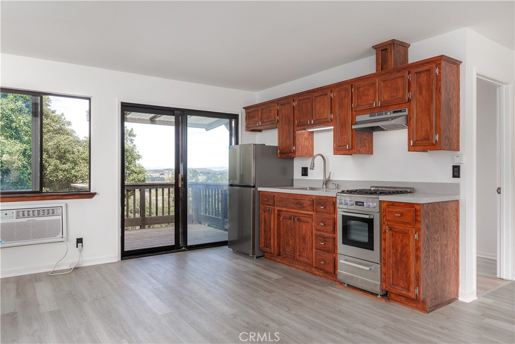 3175 Arena Avenue Atascadero, CA 93422 - Photo 21 of 40 a kitchen with stainless steel appliances granite countertop a stove a sink and a refrigerator