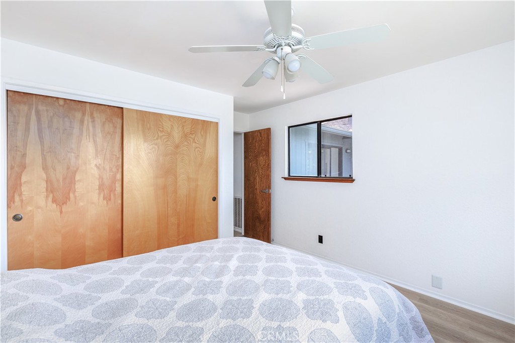 3175 Arena Avenue Atascadero, CA 93422 - Photo 23 of 40 a bedroom with a large bed and a chandelier