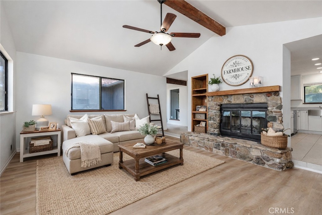3175 Arena Avenue Atascadero, CA 93422 - Photo 6 of 40 a living room with furniture a clock and a fireplace