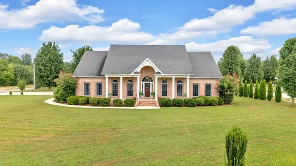 a front view of house with yard and green space