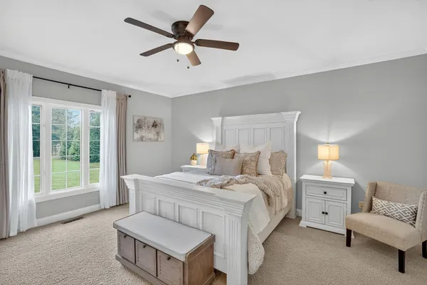 a bedroom with a bed and a chandelier