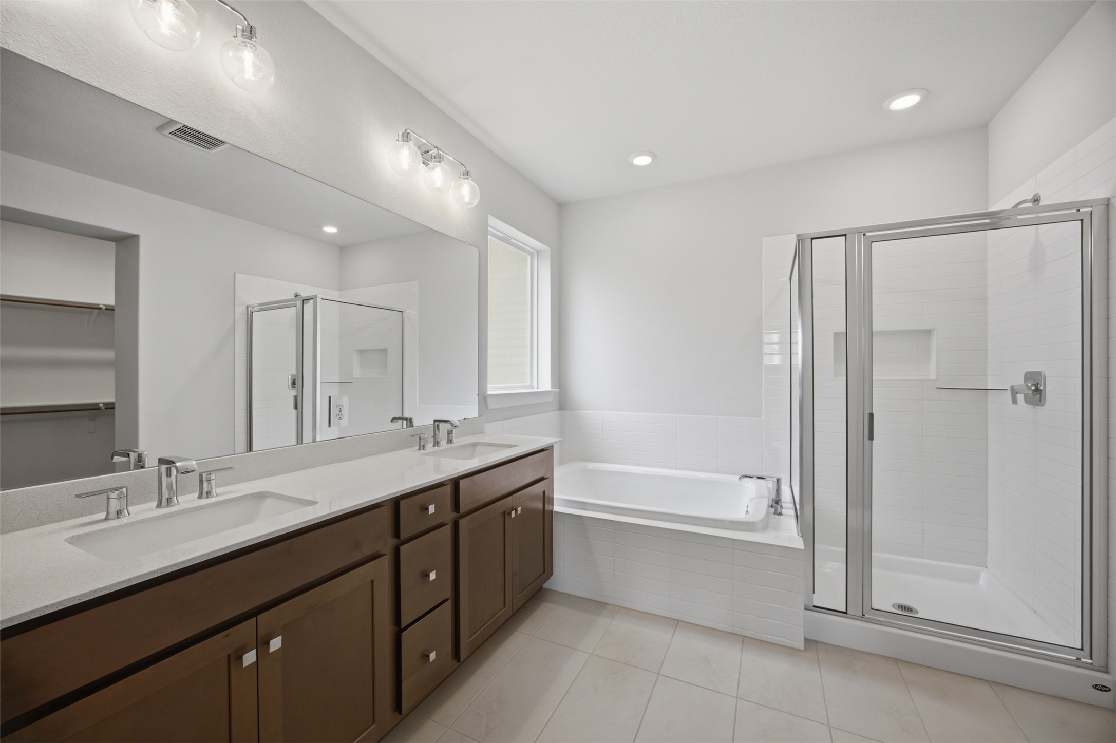 2101 Little Snake Way Georgetown, TX 78633 - Photo 21 of 37 A well-appointed primary bathroom featuring dual vanities, a separate soaking tub, and a spacious walk-in shower.