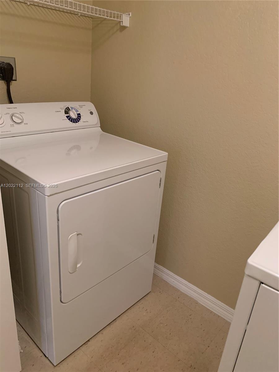 6572 West Sample Road, Unit 6572 Coral Springs, FL 33067 - Photo 8 of 17 a utility room with dryer and washer