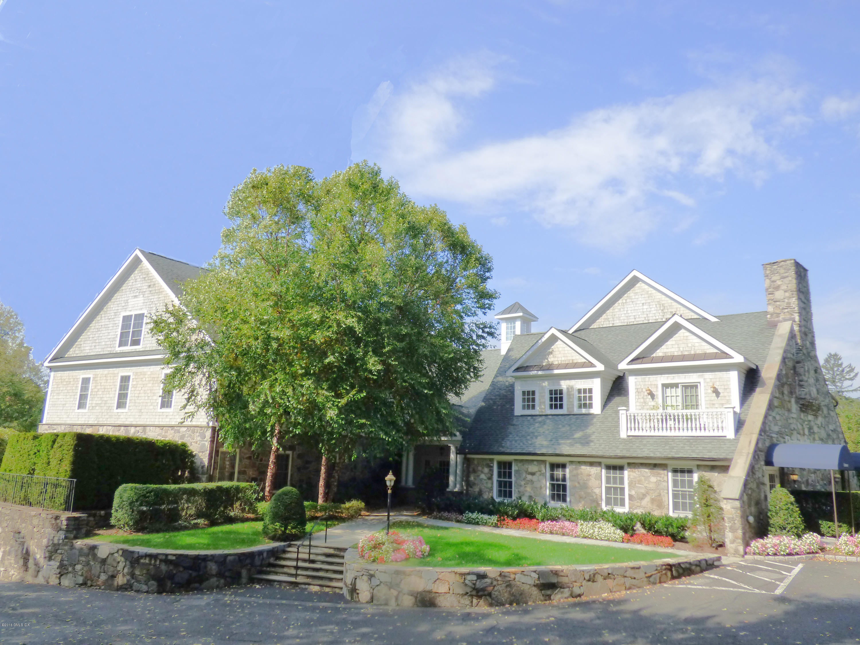 2 Dearfield Drive, Unit 2B Greenwich, CT 06831 - Photo 13 of 13 a front view of a house with a yard