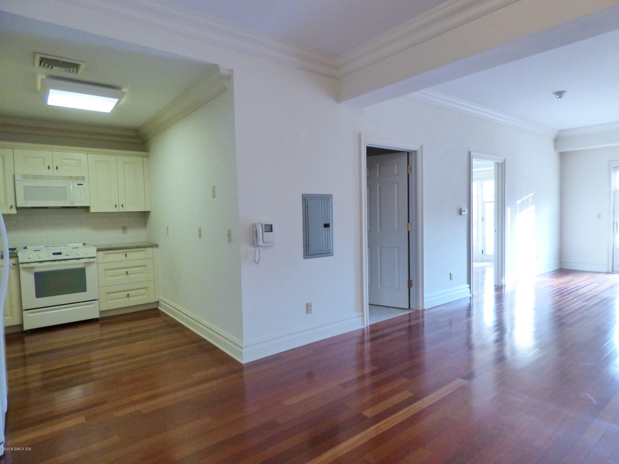 2 Dearfield Drive, Unit 2B Greenwich, CT 06831 - Photo 4 of 13 a view of a kitchen with wooden floor and a sink