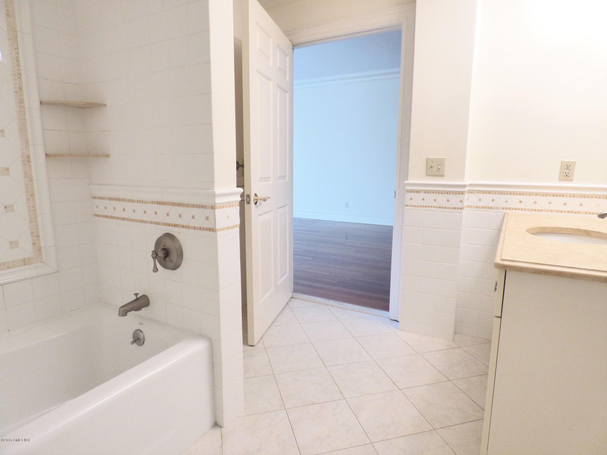 2 Dearfield Drive, Unit 2B Greenwich, CT 06831 - Photo 9 of 13 a bathroom with a bathtub and a shower