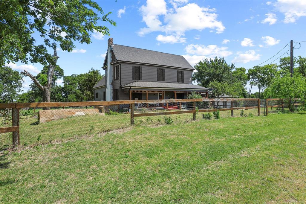 4453 Farm To Market 902 Howe, TX 75459 - Photo 3 of 40 Two-story residence featuring a gray exterior, dark roof, and a prominent chimney structure