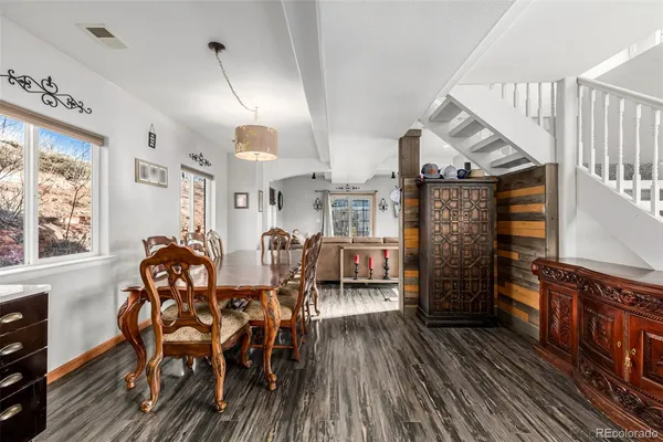 a dining room with furniture window and wooden floor