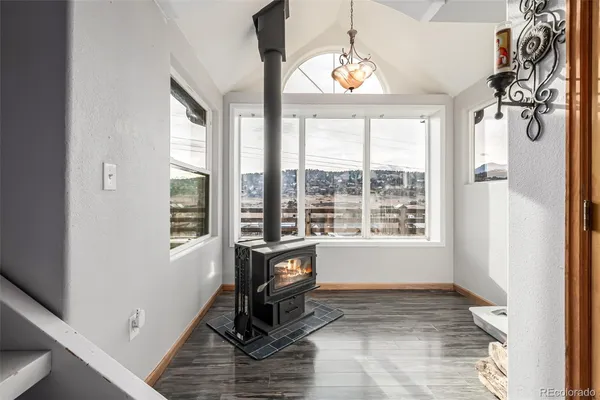a view of a livingroom with a window and hardwood