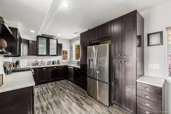 a kitchen with a refrigerator stove and sink