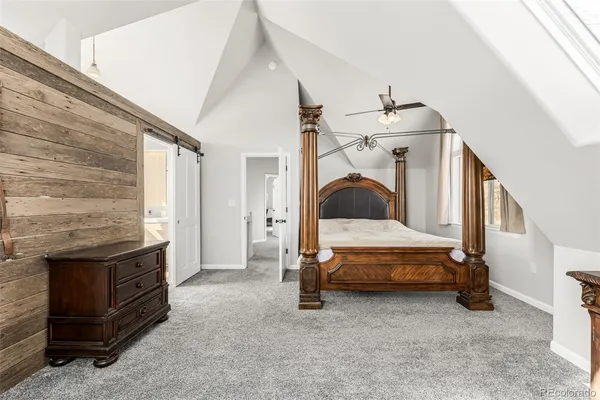 a bedroom with bed and a fireplace