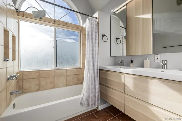 a bedroom with two beds and a large window